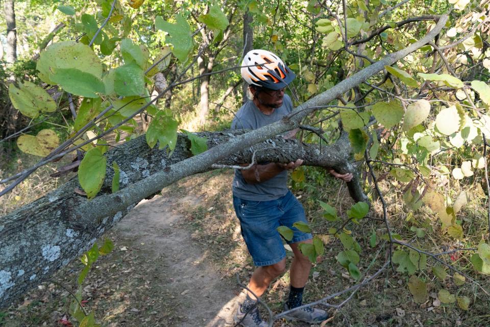 During a recent ride, Andy Phillips stopped to move a fallen tree from the yellow trail at Dornwood Nature Trails. Keeping the trails flowing and unobstructed is his primary responsibility as a volunteer trail coordinator for the system in East Topeka.