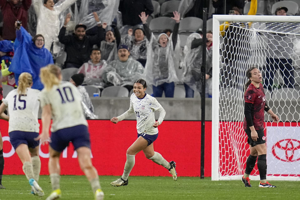 United States' Sophia Smith, center, celebrates after scoring a goal during overtime in a CONCACAF Gold Cup women's soccer tournament semifinal match against Canada, Wednesday, March 6, 2024, in San Diego. (AP Photo/Gregory Bull)