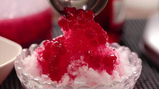 topping the shaved ice with red ruby, sweet dessert