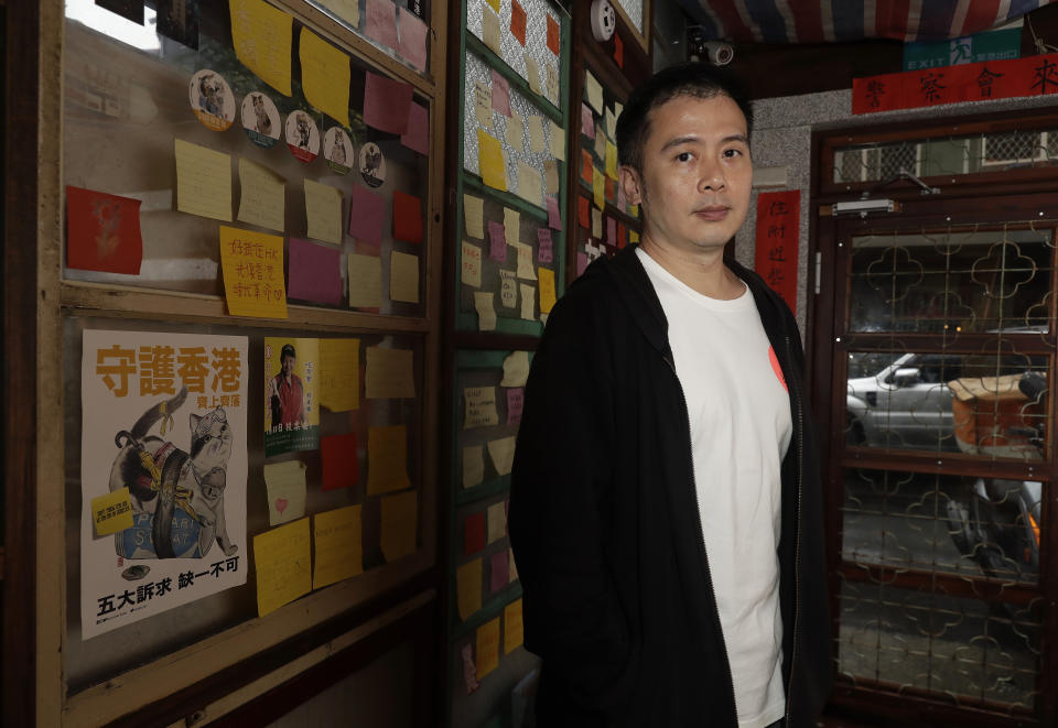 Andy Huang, a restaurateur in Taipei, poses with the “Lennon Wall,” covered in post-in notes in support of Hong Kong’s now-banned democracy movement at his restaurant in Taipei, Taiwan, on May 7, 2023. Huang said he's become desensitized to military threats from China. Taiwan’s government is racing to counter China’s military, but many on the island say they don’t share the sense of threat. (AP Photo/Chiang Ying-ying)