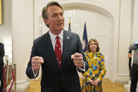 Virginia Gov. Glenn Youngkin speaks while his wife, Suzanne, listens after swearing in his Cabinet at the Mansion at the Capitol, Saturday Jan. 15, 2022, in Richmond, Va. (AP Photo/Steve Helber)