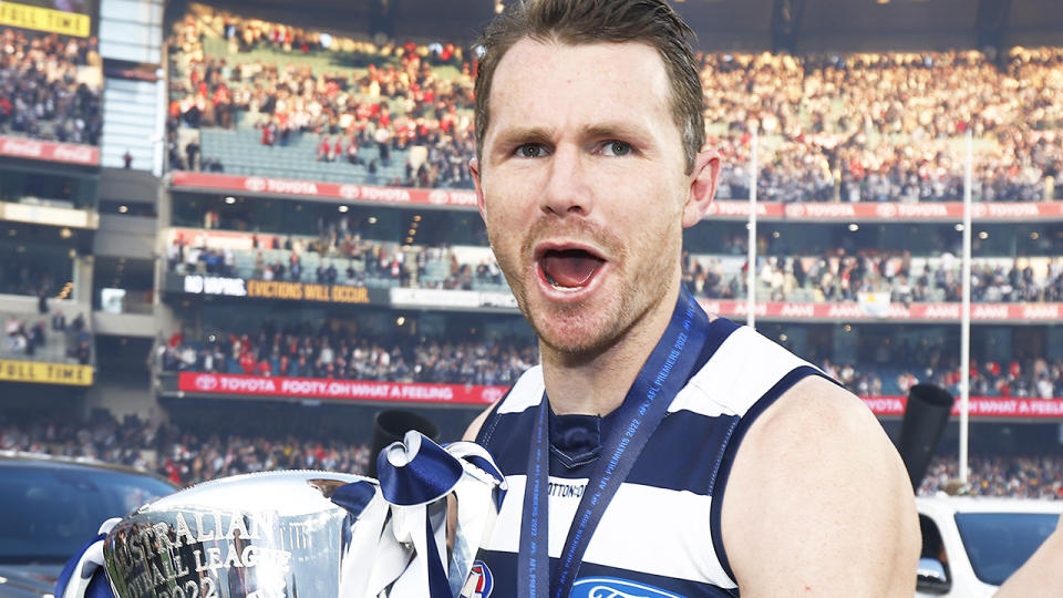 Patrick Dangerfield celebrates with the AFL premiership trophy after Geelong won the 2022 grand final.