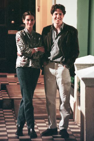 <p>Dave Benett/Getty</p> Julia Roberts and Hugh Grant on the set of 'Notting Hill'.