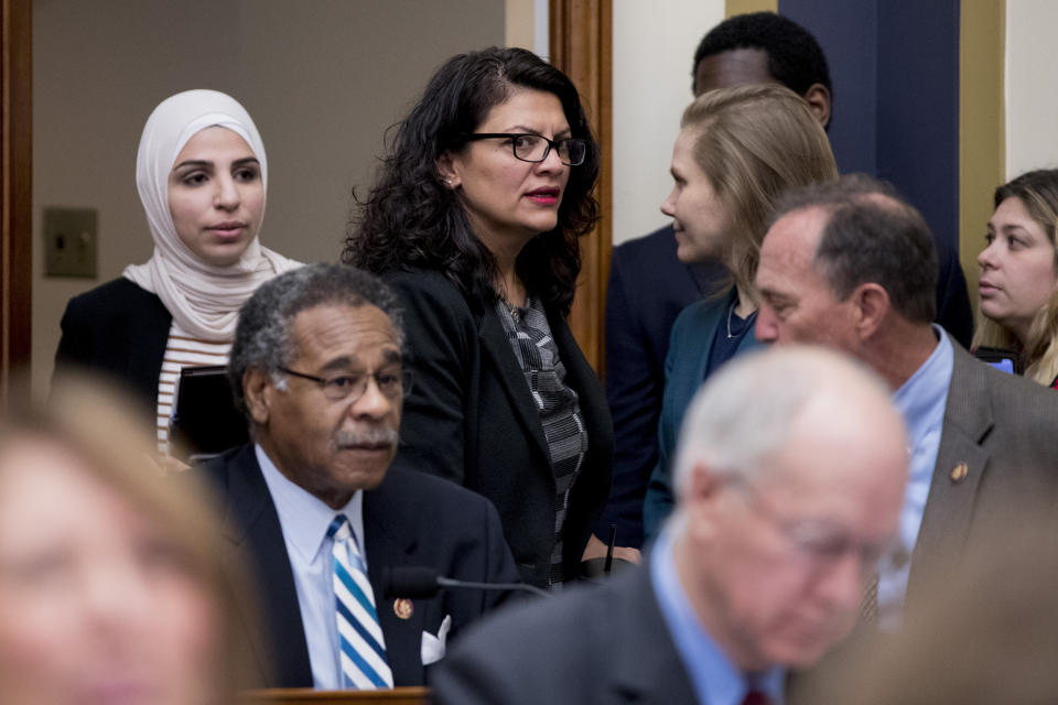 Rep. Rashida Tlaib, D-Mich., center, appears before Facebook CEO Mark Zuckerberg arrives for a House Financial Services Committee hearing on Capitol Hill in Washington, Wednesday, Oct. 23, 2019, on Facebook's impact on the financial services and housing sectors. (AP Photo/Andrew Harnik)