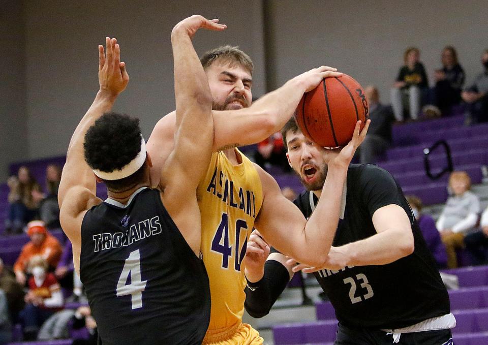 Ashland University's Derek Koch (40) drives in for a shot against Trevecca Nazarene University's Elon Smallwood (4) and Brendan Newton (23) during college men's basketball action Monday, Jan. 24, 2022 at Kates Gym. TOM E. PUSKAR/TIMES-GAZETTE.COM