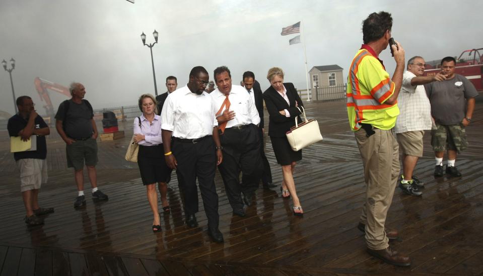 New Jersey Governor Chris Christie (C) talks with Department of Community Affairs Commissioner Richard Constable and CEO of the New Jersey Economic Development Authority Michelle Brown (R) as he tours the fire area with his Deputy Chief of Staff Bridget Anne Kelly (L) at the boardwalk in Seaside Heights, New Jersey on September 12, 2013 in this handout photo obtained by Reuters on January 9, 2014. Christie said at a news conference on January 9, 2014 that he had fired Kelly in the wake of a scandal involving the closure of lanes on the George Washington bridge during a political campaign in September. (REUTERS/Tim Larsen/Governor's Office/Handout via Reuters)