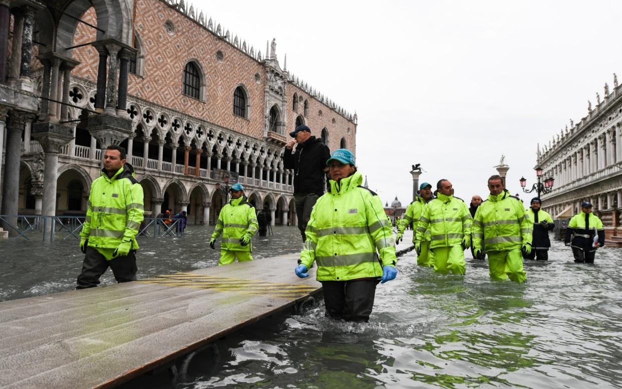 Visitors walk in flooded Venice, in the morning of November 17, 2019 during 