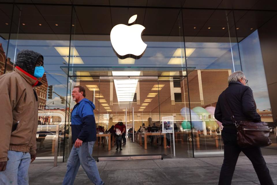 The Apple company logo hangs above an Apple retail store on November 28, 2022 in Chicago, Illinois.