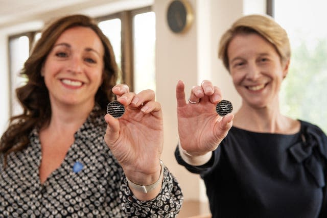 Ellie Orton (left), chief executive of NHS Charities Together and Amanda Pritchard, chief exective of NHS England holding the NHS 75th Anniversary 50p 