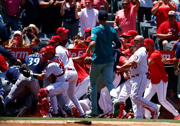 The Seattle Mariners and the Los Angeles Angels clear the benches after Jesse Winker #27 of the Seattle Mariners charged the Angels dugout after being hit by a pitch in the second inning at Angel Stadium of Anaheim on June 26, 2022 in Anaheim, California.