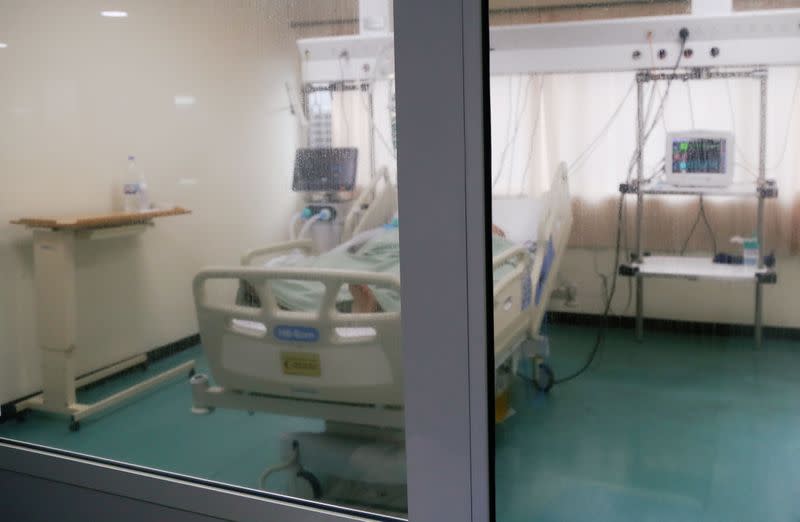 A patient suffering from the coronavirus disease (COVID-19), lies in bed at an intensive care unit at Rafik Hariri University Hospital, in Beirut