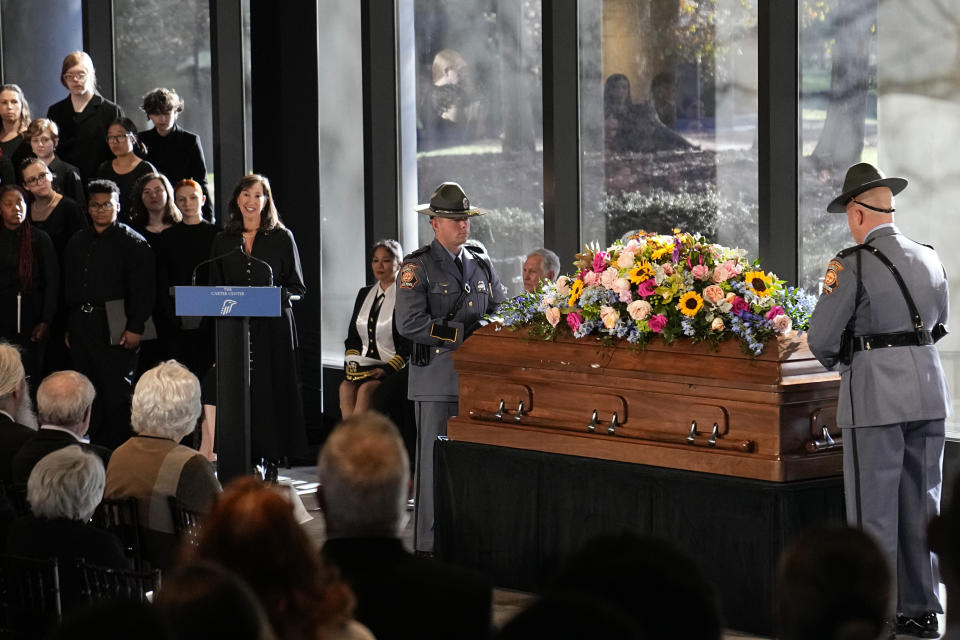 Members of the Georgia State Patrol honor guard stand at the casket of former first lady Rosalynn Carter as Paige Alexander, CEO of The Carter Center, speaks during a repose service in the lobby of the Jimmy Carter Presidential Library and Museum in Atlanta, Monday, Nov. 27, 2023. (AP Photo/Brynn Anderson, Pool)