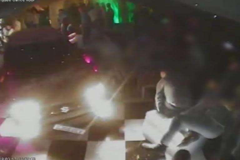 CCTV captures moment man drives car onto crowded club's dancefloor