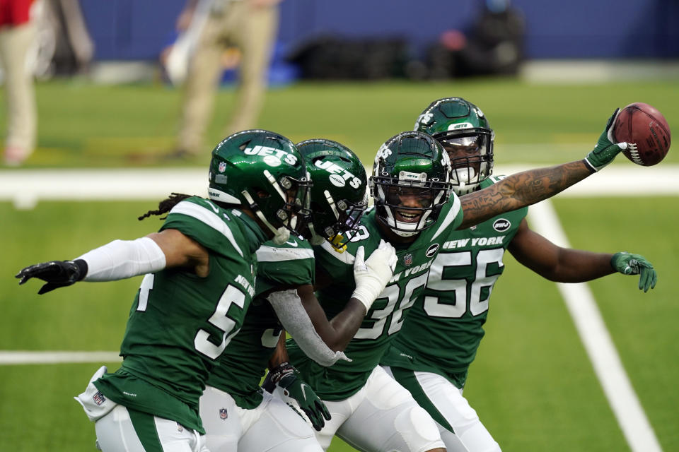 New York Jets cornerback Lamar Jackson, second from right, celebrates with teammates after recovering a blocked punt against the Rams. (AP Photo/Ashley Landis)