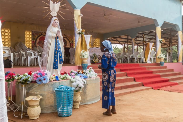 A member of the Very Holy Church of Jesus Christ of Baname arrives at the Nazareth church in Djidja to attend a service