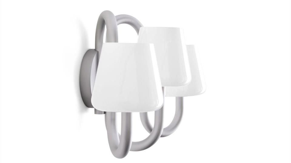 loopy metal sconce with milky white opaque glass shades