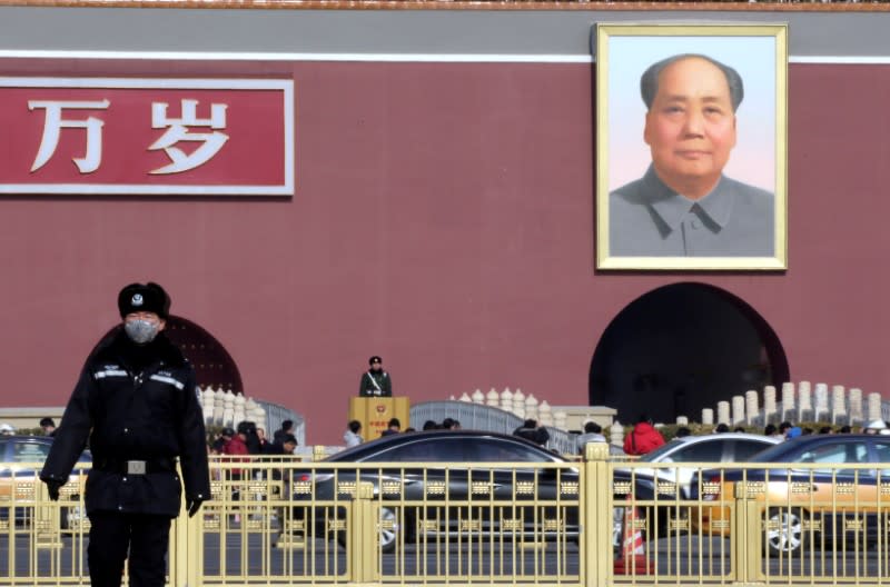 Policeman wearing a mask is seen at Tiananmen Square in Beijing