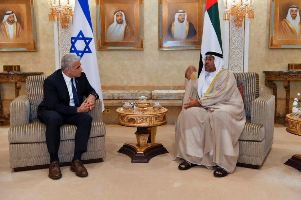 Israeli Foreign Minister Yair Lapid sits next to United Arab Emirates Minister of State Ahmed Ali Al Sayegh during their meeting in Abu Dhabi, United Arab Emirates June 29, 2021. Shlomi Amsalem/Government Press Office (GPO)/Handout via REUTERS. THIS IMAGE HAS BEEN SUPPLIED BY A THIRD PARTY.MANDATORY CREDIT.THIS PICTURE WAS PROCESSED BY REUTERS TO ENHANCE QUALITY. AN UNPROCESSED VERSION HAS BEEN PROVIDED SEPARATELY.