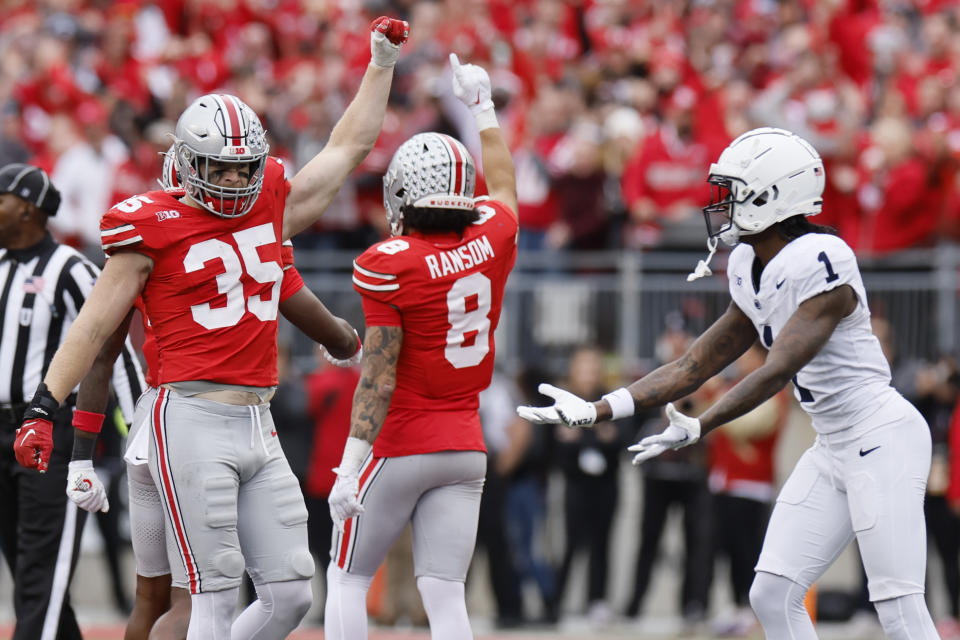 Ohio State linebacker Tommy Eichenberg, left, and defensive back Lathan Ransom celebrate stopping Penn State on fourth down during the second half of an NCAA college football game Saturday, Oct. 21, 2023, in Columbus, Ohio. (AP Photo/Jay LaPrete)