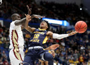 <p>Ja Morant #12 of the Murray State Racers attempts a shot against Christ Koumadje #21 of the Florida State Seminoles in the first half during the second round of the 2019 NCAA Men’s Basketball Tournament at XL Center on March 23, 2019 in Hartford, Connecticut. (Photo by Rob Carr/Getty Images) </p>