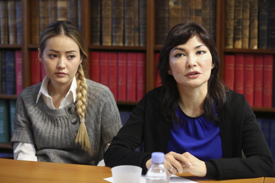 Mukhtar Ablyazov's wife Alma Shalabayeva, right, and daughter Madina Ablyazova, left, speak with journalists, during a press conference held with her lawyers, in Paris, Tuesday Jan. 7, 2014. An opposition leader from a country that has been ruled by the same man since 1989, a former banker accused of siphoning off billions, Mukhtar Ablyazov has been jailed since police special forces seized him July 31 in the south of France. (AP Photo/Remy de la Mauviniere)