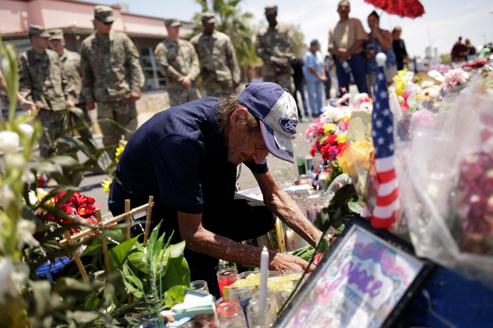 Antonio Basco arranges flowers at a memorial for the victims of the shooting in El Paso, Texas, Aug. 15, 2019. Basco's wife, Margie, was killed in the massacre. (Jose Luis Gonzalez/Reuters)