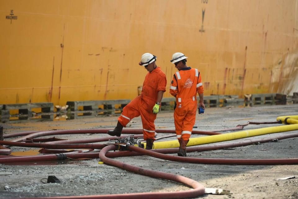 PHOTO: Firefighting teams set up hoses for dewatering and firefighting efforts on the motor vessel Grande Costa d'Avorio at Port Newark, in Newark, New Jersey, July 8, 2023. (U.S. Coast Guard photo by Petty Officer 2nd Class Diolanda Caballero)
