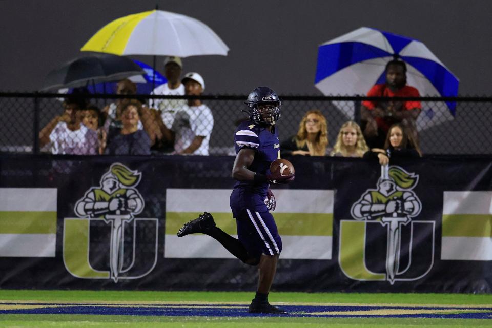 University Christian's Orel Gray #4 scores a touchdown during the second quarter of a regular season high school football game Friday, Aug. 26, 2022 at University Christian School in Jacksonville. The University Christian Fightin' Christians defeated Union County Fightin' Tigers 33-14 after a 30 minute lightning delay at the end of the third quarter. 