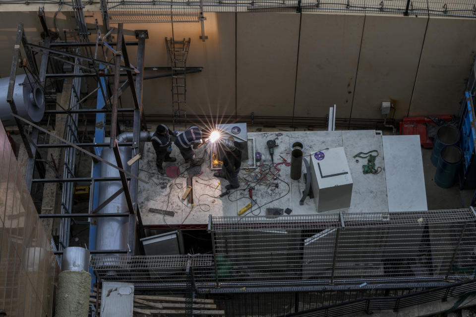 Workers install a new generator for the U.N. headquarters in Beirut, Lebanon, March 1, 2022. Private generators are ubiquitous in parts of the Middle East, spewing hazardous fumes into homes and business across the country, almost 24 hours a day. As the world looks for renewable energy to tackle climate change, Lebanon, Iraq, Gaza and elsewhere rely on diesel-powered private generators just to keep the lights on. The reason is state failure: In multiple countries, governments can’t maintain a functioning central power network, whether because of war, conflict or mismanagement and corruption. (AP Photo/Hassan Ammar)