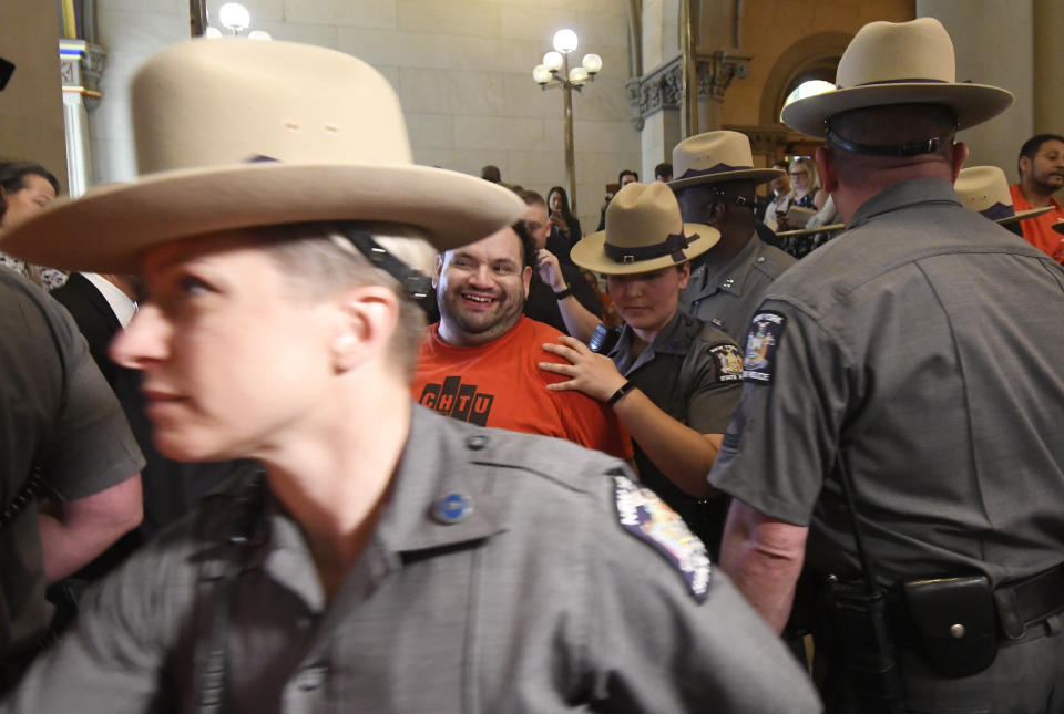 Protesters are arrested by state police as tenants and members of the Upstate Downstate Housing Alliance from across the state, demand New York Gov. Andrew Cuomo and state legislators pass universal rent control legislation that would strengthen and expand tenants rights across the state of New York before rent laws expire on June 15th during a protest rally at the state Capitol Tuesday, June 4, 2019, in Albany, N.Y. (AP Photo/Hans Pennink)\