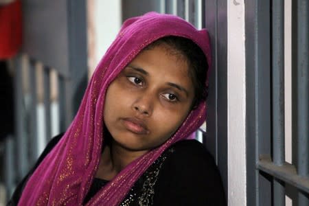 FILE PHOTO: A Rohingya woman is seen detained in a police station after a fishing boat carrying more than sixty Rohingya refugees was found beached at Rawi island