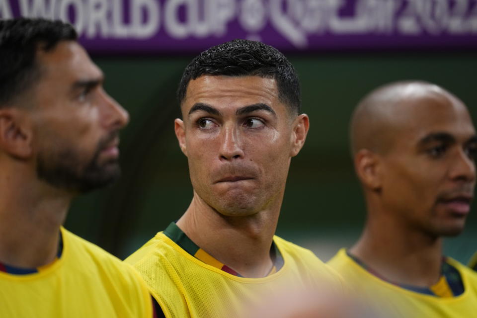 Portugal's Cristiano Ronaldo, middle, looks on from the bench before during the World Cup round of 16 soccer match between Portugal and Switzerland, at the Lusail Stadium in Lusail, Qatar, Tuesday, Dec. 6, 2022. (AP Photo/Natacha Pisarenko)