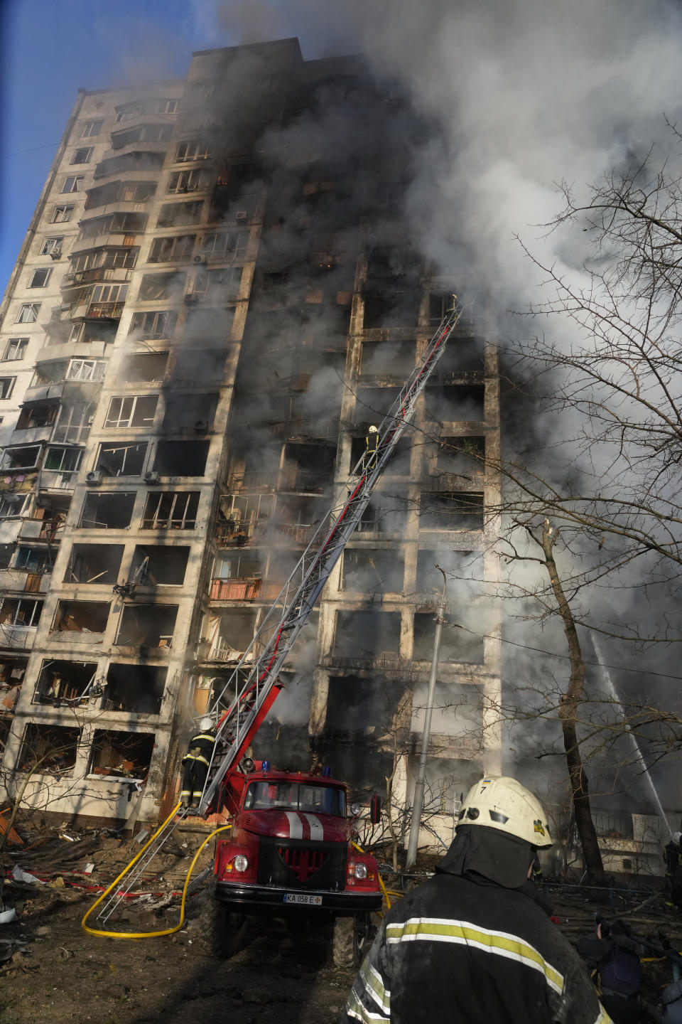 Firefighters work in an apartment building damaged by shelling in Kyiv, Ukraine, Tuesday, March 15, 2022. (AP Photo/Efrem Lukatsky)