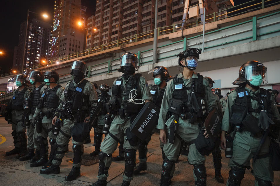 Riot police stand guard after pushing back protesters demonstrating against the new security law during the anniversary of the Hong Kong handover from Britain, Wednesday, July. 1, 2020, in Hong Kong. Hong Kong police have made their first arrests under a new national security law imposed by mainland China. The law, which took effect Tuesday night, makes activities deemed subversive or secessionist punishable by up to life in prison. (AP Photo/Vincent Yu)