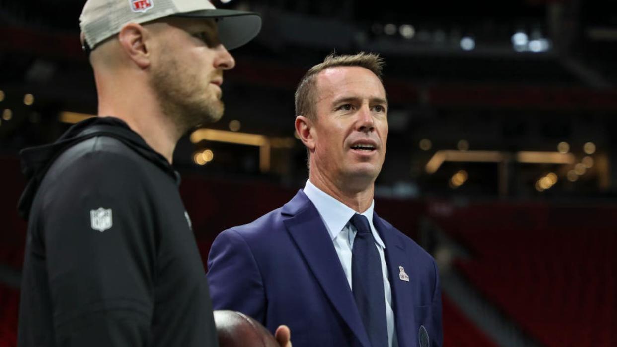 <div>ATLANTA, GEORGIA - OCTOBER 15: Former Atlanta Falcons quarterback Matt Ryan talks with Atlanta Falcons coach T. J. Yates prior to an NFL football game against the Washington Commanders at Mercedes-Benz Stadium on October 15, 2023 in Atlanta, Georgia. (Photo by Kara Durrette/Getty Images)</div>