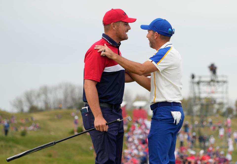 Bryson DeChambeau and Sergio Garcia on the 15th green during day three singles rounds at the Ryder Cup.