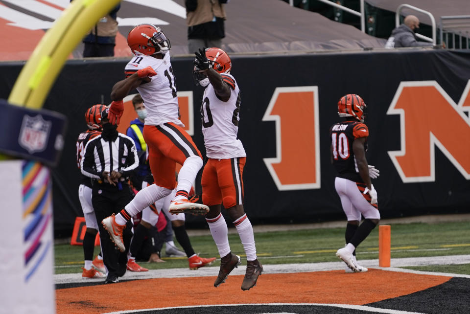 Cleveland Browns' Donovan Peoples-Jones (11) celebrates his touchdown reception with Jarvis Landry (80) during the second half of an NFL football game against the Cincinnati Bengals, Sunday, Oct. 25, 2020, in Cincinnati. (AP Photo/Bryan Woolston)