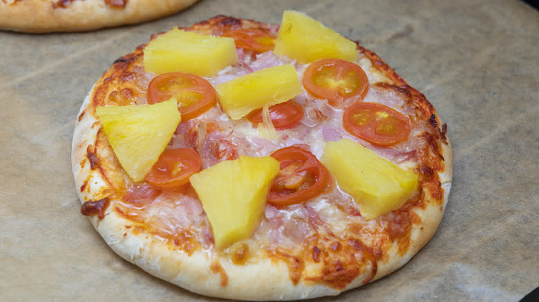 Mini pizza with tomato and pineapple