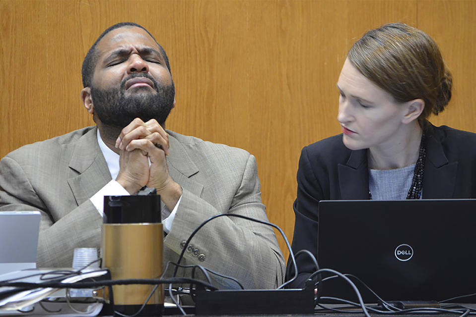 Defendant Willie Cory Godbolt, left, reacts during testimony from his 12-year-old daughter, My'Khyiah Godbolt, that he beat her while defense attorney Katherine Poor comforts him, on Monday, Feb. 17, 2020, during the third day of his capital murder trial at the Pike County Courthouse in Magnolia, Miss. Godbolt, 37, is on trial, for the May 2017 shooting deaths of eight people in Brookhaven. (Donna Campbell/The Daily Leader via AP, Pool)
