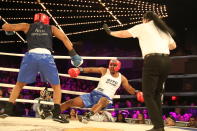 <p>Larry Carson (red) lands on the ropes after being hit by Kevon Sample (blue) in the LT Rumble Match at the NYPD Boxing Championships at the Hulu Theater at Madison Square Garden on March 15, 2018. (Gordon Donovan/Yahoo News) </p>