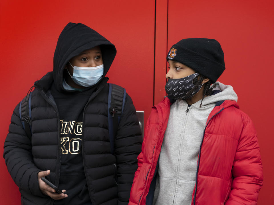 Students wait for the doors to open at P.S. 134 Henrietta Szold Elementary School, Monday, Dec. 7, 2020, in New York. Public schools reopened for in-school learning Monday after being closed since mid-November. (AP Photo/Mark Lennihan)