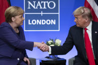 President Donald Trump shakes hands with German Chancellor Angela Merkel during the NATO summit at The Grove, Wednesday, Dec. 4, 2019, in Watford, England. (AP Photo/ Evan Vucci)