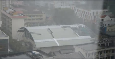 The roof of a building is damaged during a storm in Ho Chi Minh City, as Typhoon Damrey descends on southern Vietnam, in this still image taken from social media video, November 4, 2017. Pham Anh Phu - MediaOnline/via REUTERS