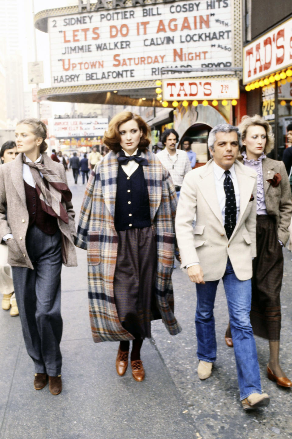 Designer Ralph Lauren and models walk on 42nd Street in Times Square, 1977. - Credit: Lynn Karlin/Fairchild Archive