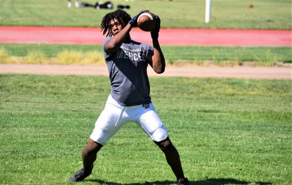 Buhach Colony High School senior Eric Thrasher hauls in a catch during practice on Tuesday, Aug. 15, 2023 in Atwater, Calif.