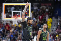 New Orleans Pelicans forward Brandon Ingram (14) reacts after making a 3-point basket at the buzzer to end the first quarter during an NBA basketball game against the Los Angeles Lakers in New Orleans, Sunday, April 14, 2024. (AP Photo/Gerald Herbert)