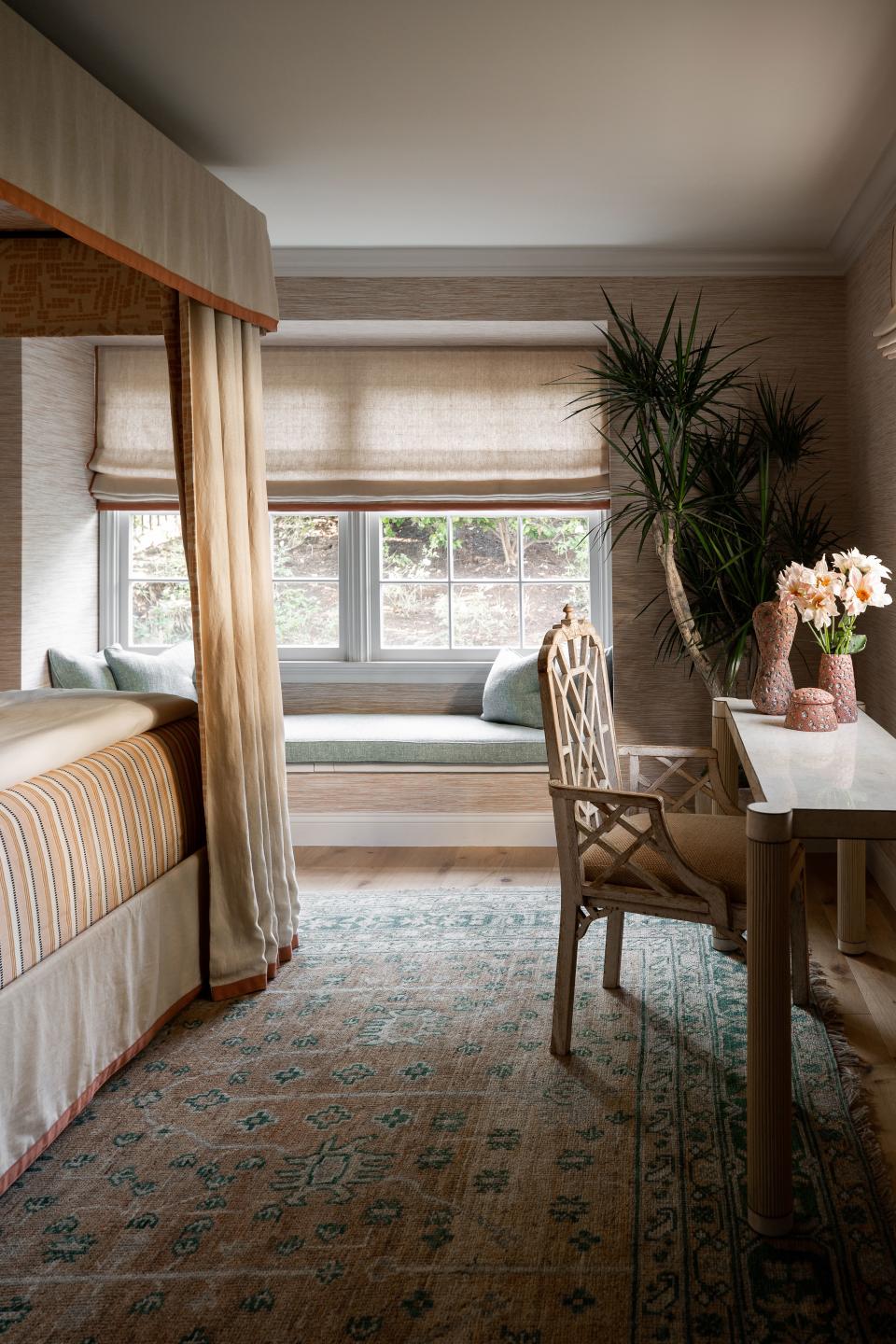 The clever approach to sourcing and styling is apparent here in the guest suite. A printed rug and four-poster bed adds a sense of depth and history, while simple window treatments and shapely furniture more typical of a Californian home keep things breezy.
