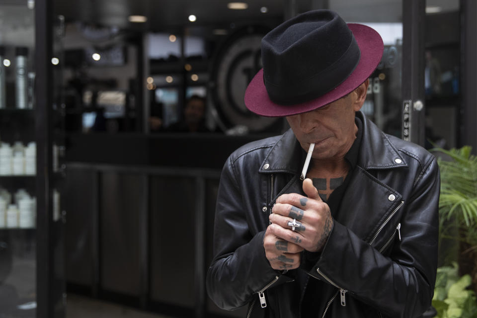 Giuseppe Franco smokes a cigarette outside his hair salon Tuesday, May 7, 2019, in Beverly Hills, Calif. Beverly Hills is considering outlawing the sale of tobacco products, a move that would make the glamorous California city the first in the nation to enact such a ban. (AP Photo/Jae C. Hong)