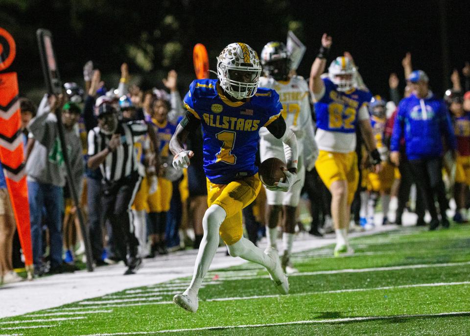 Tookie Watts of the Blue Team scores a touchdown against the Gold Team in the Rotary South All Star game at Fort Myers High School on Wednesday, Dec. 13, 2023. The Gold team won in a thriller.