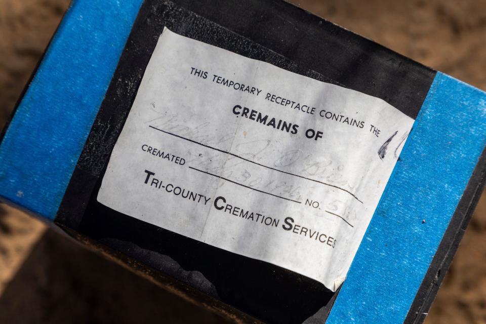 A box with a label from the Tri-County Cremation Services sits on top of a dirt hill inside the Oak Grove Burying Ground in Taylor on Wednesday, April 12, 2023. 